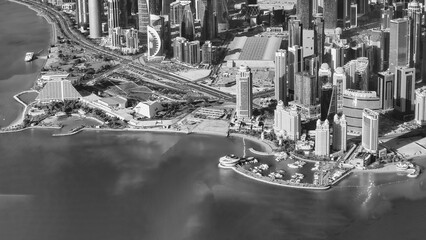 Canvas Print - Aerial view of Doha skyline from airplane. Corniche and modern buildings, Qatar