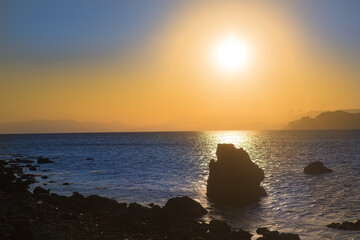 Wall Mural - Beautiful sunset over the rocks