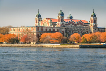 Wall Mural - Ellis Island skyline from hudson river at golden autumn in New York , USA