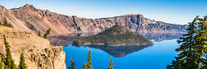 Wall Mural - panoramic view of crater lake on a calm and clear summer morning.
