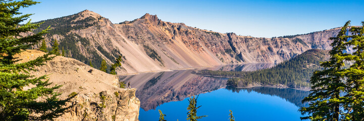 Wall Mural - panoramic view of crater lake on a calm and clear summer morning.