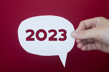 Poster - Speech bubble in front of colored background with the number 2023.