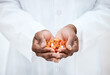 © M Einero/peopleimages.com - Hand, pills and doctor holding medicine for cancer treatment closeup in a medical clinic. Supplements, vitamins and antibiotics capsule or pill for medicare with open hand of pharmacist