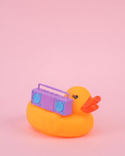 Rubber Duck With Boombox Audio Player On A Pink Background. Party Concept