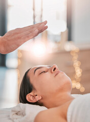 Spa, woman and healing energy for head, massage or body wellness to relax in luxury, resort or bed. Girl, reiki and physical therapy for health, peace or mindfulness with spiritual zen, hand or light