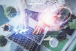 © peshkova - Double exposure of woman hands working on computer and data theme hologram drawing. Top View. Technology concept.