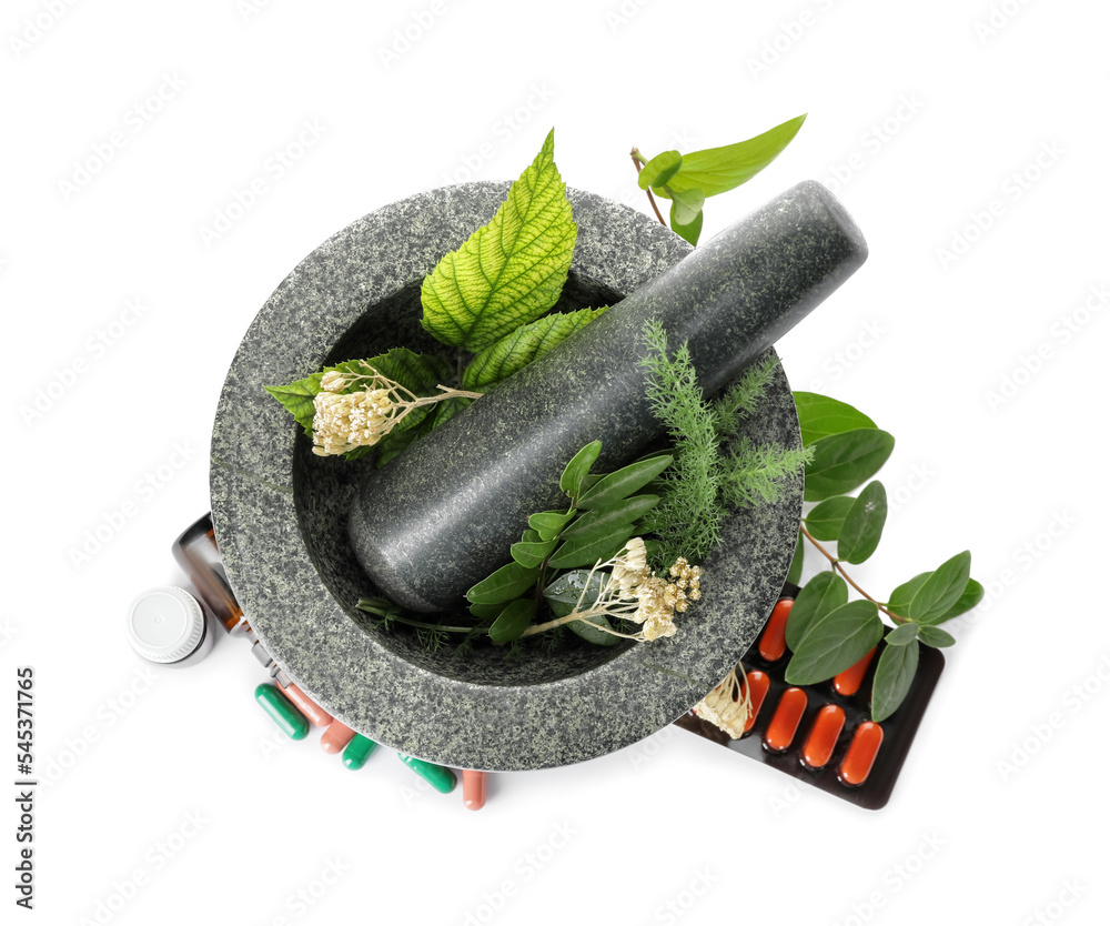 Stone mortar with herbs and different pills on white background