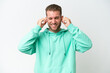 © luismolinero - Young handsome caucasian man isolated on white background frustrated and covering ears