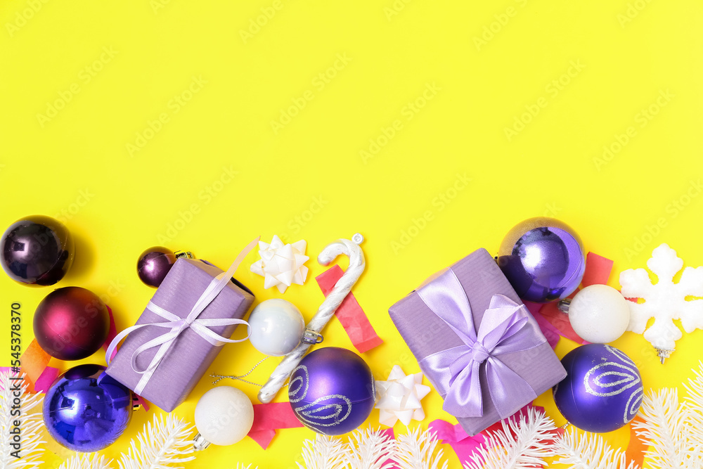 Composition with Christmas gifts, decorations and confetti on yellow background