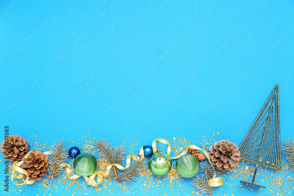 Composition with Christmas decorations, cones, fir branches and confetti on color background