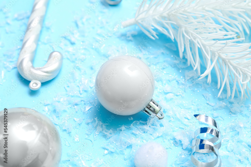 Composition with Christmas decorations and snow on color background, closeup