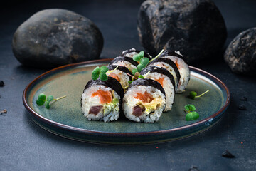 Poster - Sushi rolls set with tuna, salmon, Philadelphia cheese, avocado and microgreens on a gray background.