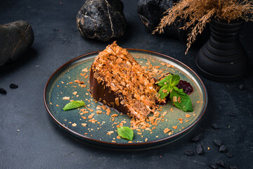 Wall Mural - Slice of chocolate cake with jam and mint on a plate.