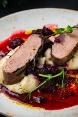 Poster - Duck fillet with mashed potatoes and blackberry sauce, closeup.