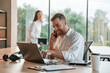 © standret - Successful deal. Using laptop. Man and woman are working in the modern office together