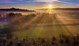 Fototapeta  - Poranny widok pól o wsi z promieniami słońca jesienią