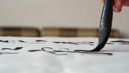 Wall Mural - an old chinese calligrapher is writing calligraphy characters, creating calligraphy works