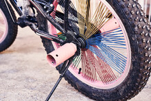 A Pink Bike With Spikes On It's Spokes And Wheel Hubs That Are Stuck To The Rim