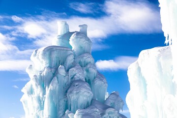 Wall Mural - Beautiful view of a huge ice formation against the blue sky with floating white clouds