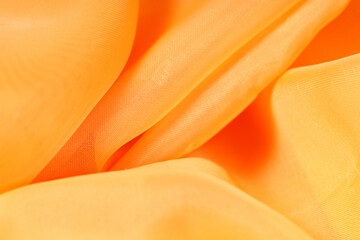 Poster - orange silk fabric. fabric texture wavy