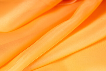 Poster - orange silk fabric. fabric texture wavy