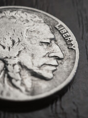 Wall Mural - us nickel lies on a dark table surface. coin 5 cents closeup. indian head nickel. news about usa eco