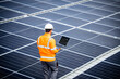 © littlewolf1989 - Solar energy worker or engineer with his laptop computer checking installation and productivity of new solar power plant.