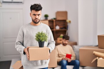 Wall Mural - Homosexual couple moving to a new home skeptic and nervous, frowning upset because of problem. negative person.