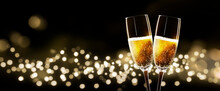 2 Champagne Glasses Celebrating Christmas And New Year With A Blurred Bokeh Background
