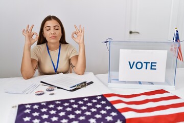 Sticker - Young brunette woman at political election sitting by ballot relax and smiling with eyes closed doing meditation gesture with fingers. yoga concept.