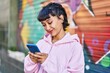 © Krakenimages.com - Young woman smiling confident using smartphone at street