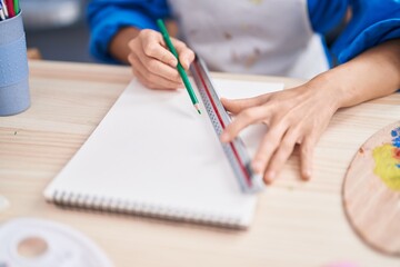 Poster - Young woman artist drawing on notebook at art studio