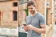 © Krakenimages.com - Young caucasian man smiling confident using smartphone at street