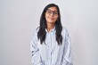 © Krakenimages.com - Young hispanic woman wearing glasses relaxed with serious expression on face. simple and natural looking at the camera.