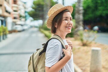 Wall Mural - Middle age woman tourist smiling confident wearing backpack at street