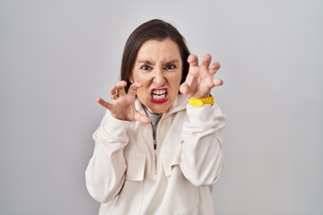 Canvas Print - Middle age hispanic woman standing over isolated background smiling funny doing claw gesture as cat, aggressive and sexy expression