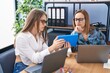 © Krakenimages.com - Two women business workers using laptop and touchpad working at office
