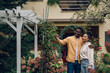 © Zamrznuti tonovi - Multiracial couple holding keys and standing outside their new home