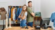 © Krakenimages.com - Two hispanic shopkeepers smiling happy standing with arms crossed gesture at clothing store.
