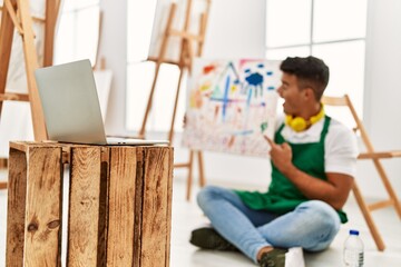 Wall Mural - Young hispanic man smiling confident having online draw class at art studio