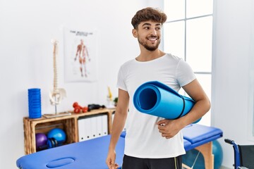 Sticker - Young arab man patient smiling confident holding yoga mat at clinic