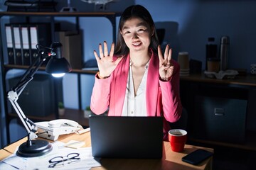 Poster - Chinese young woman working at the office at night showing and pointing up with fingers number eight while smiling confident and happy.