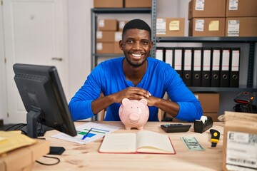 Sticker - African american man working at small business ecommerce with piggy bank smiling with a happy and cool smile on face. showing teeth.