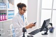 © Krakenimages.com - Young hispanic man pharmacist using smartphone working at pharmacy