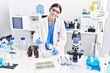 © Krakenimages.com - Young hispanic woman wearing scientist uniform working at laboratory