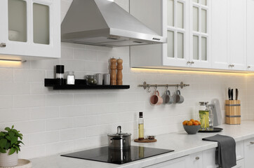 Canvas Print - Modern range hood and furniture in kitchen