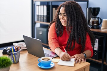 Canvas Print - African american woman business worker using laptop writing on notebook at office