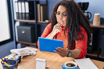 Canvas Print - African american woman business worker using touchpad with serious expression at office