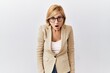 © Krakenimages.com - Middle age blonde business woman standing over isolated background afraid and shocked with surprise and amazed expression, fear and excited face.