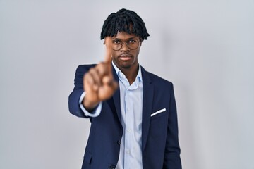 Sticker - Young african man with dreadlocks wearing business jacket over white background pointing with finger up and angry expression, showing no gesture